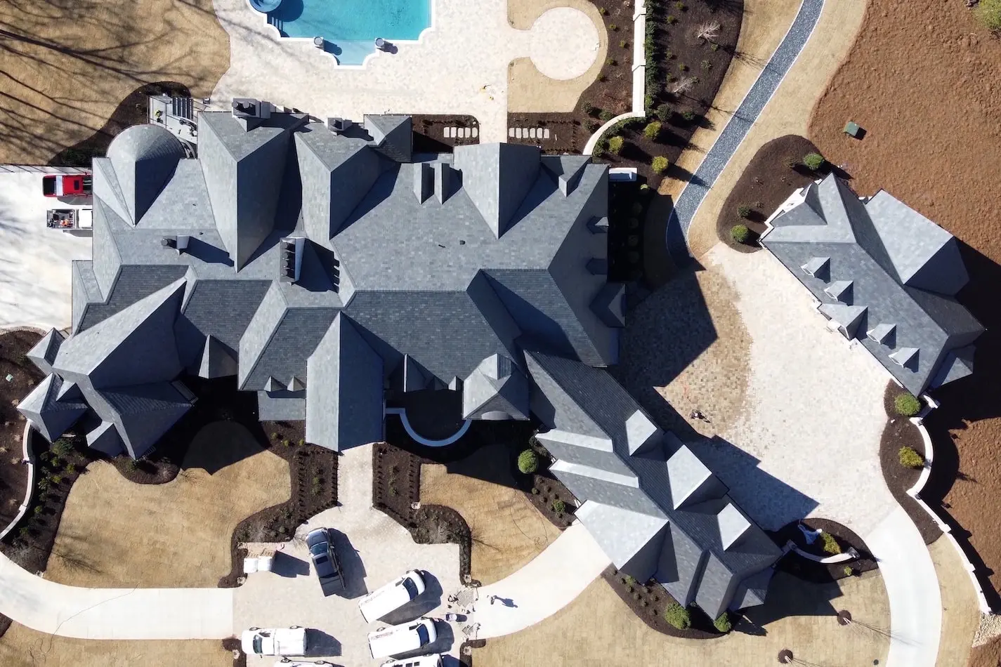 Residential house with slate roofing and custom metal chimney caps.