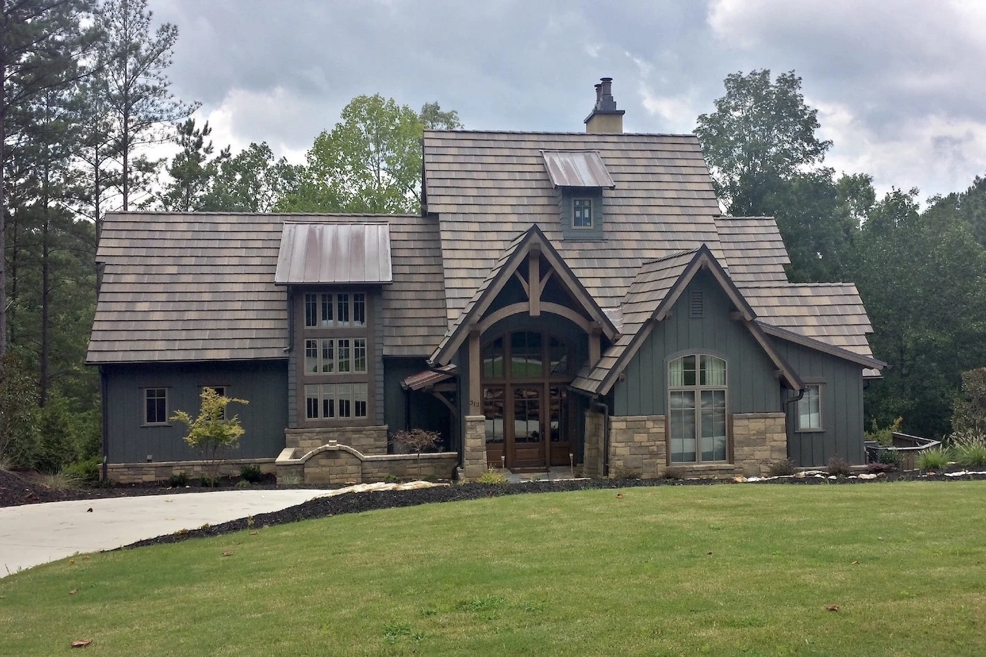 Residential house with tile and standing seam metal roofing.
