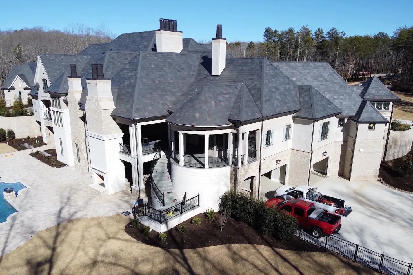 Residential house with slate roofing and custom metal chimney caps.