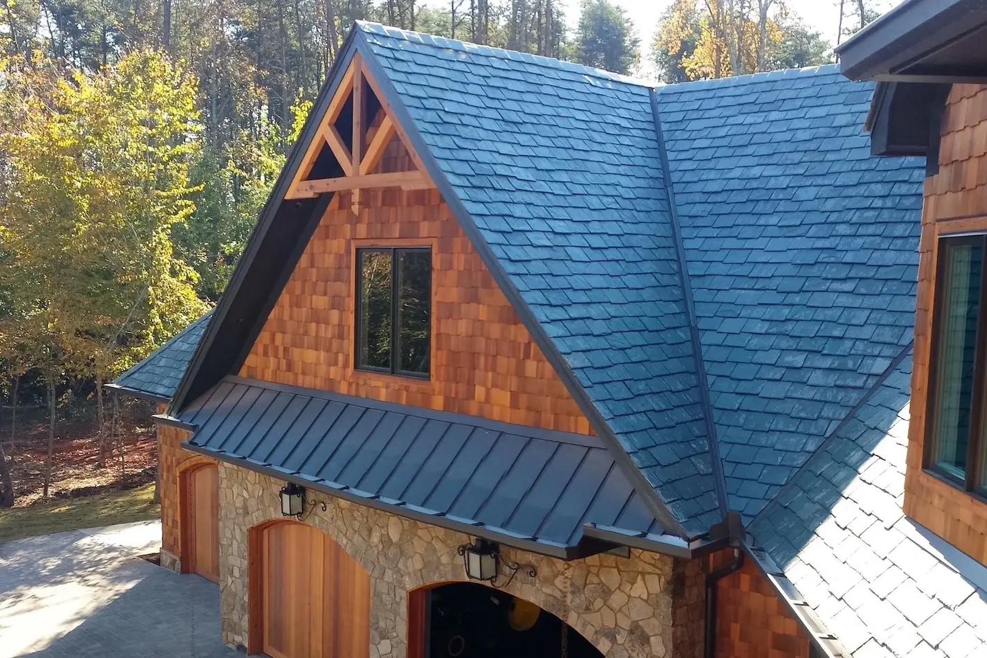 Residential house with slate and standing seam metal roofing.